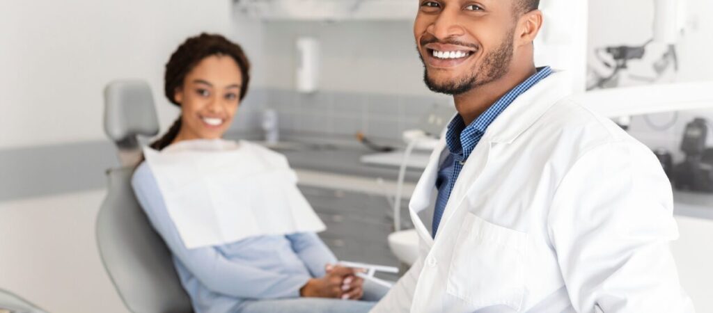 Google Ads For Dentists, Pediatric Dentist Smiling with his patient
