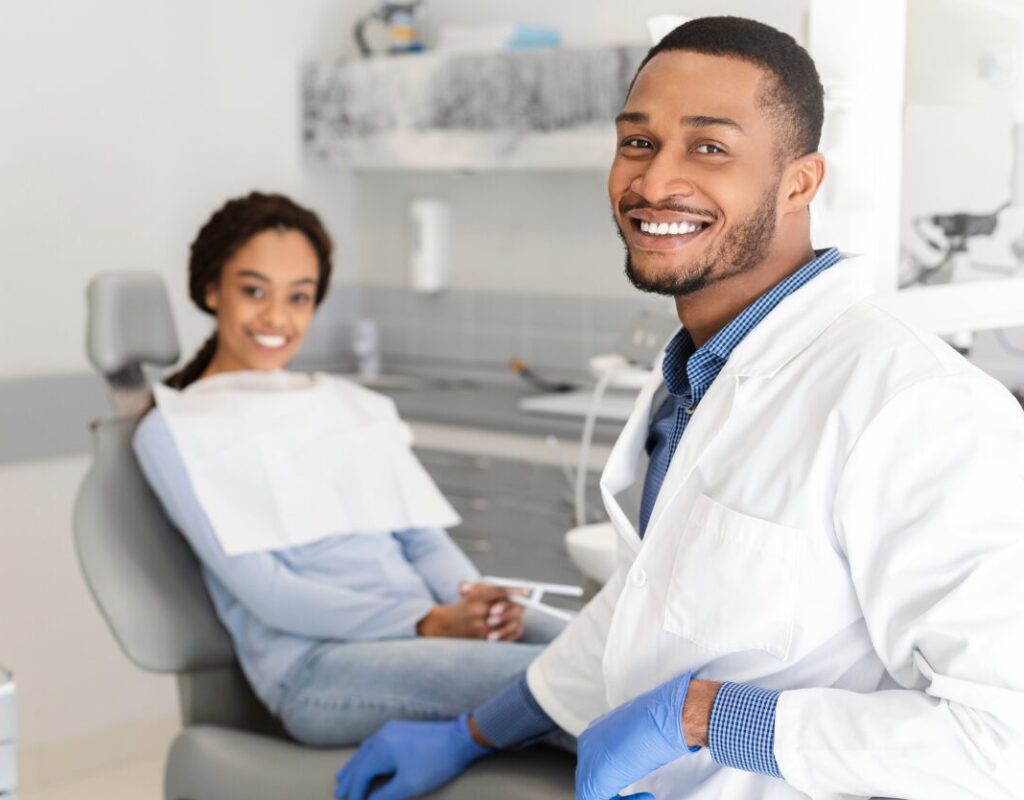 Google Ads For Dentists, Pediatric Dentist Smiling with his patient